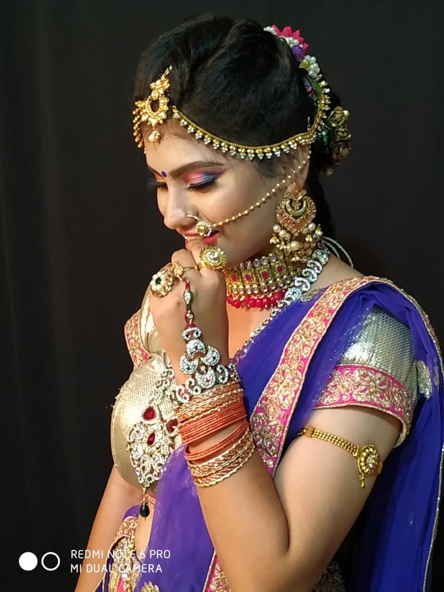 Ravet bride in pink lehenga with intricate mehndi hands in prayer pose — Shrungar bridal makeup
